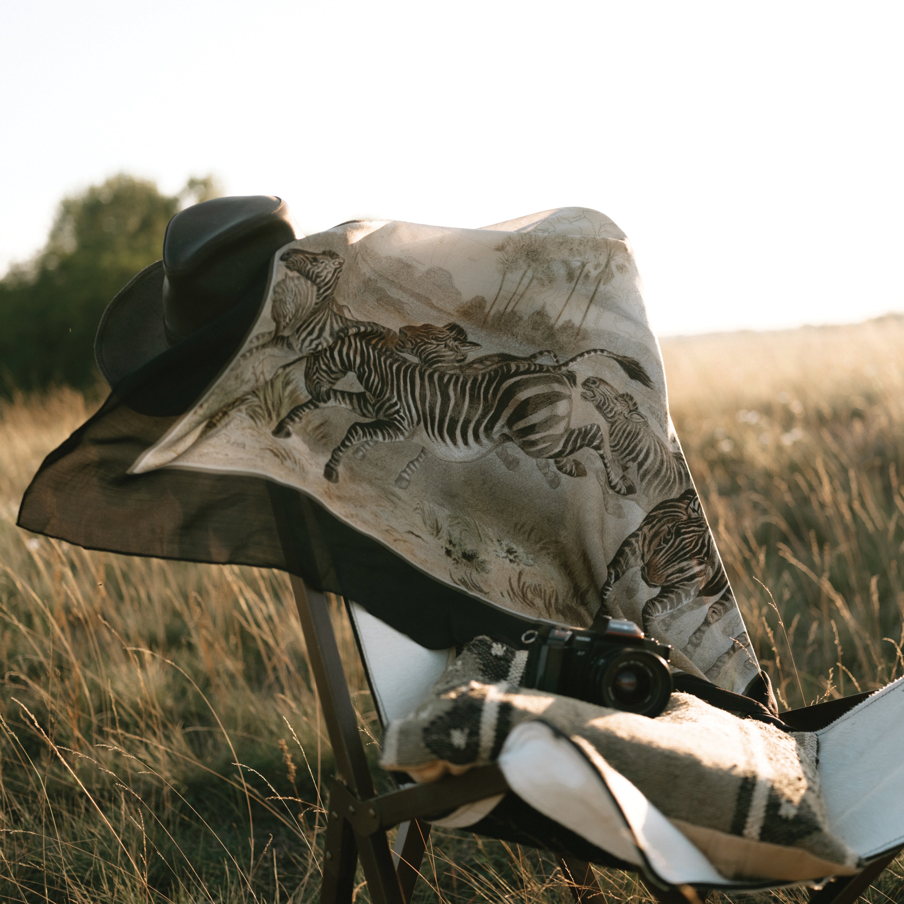 Maouli shawl silk and cashmere Zawadi on chair outdoors fields wind adventure