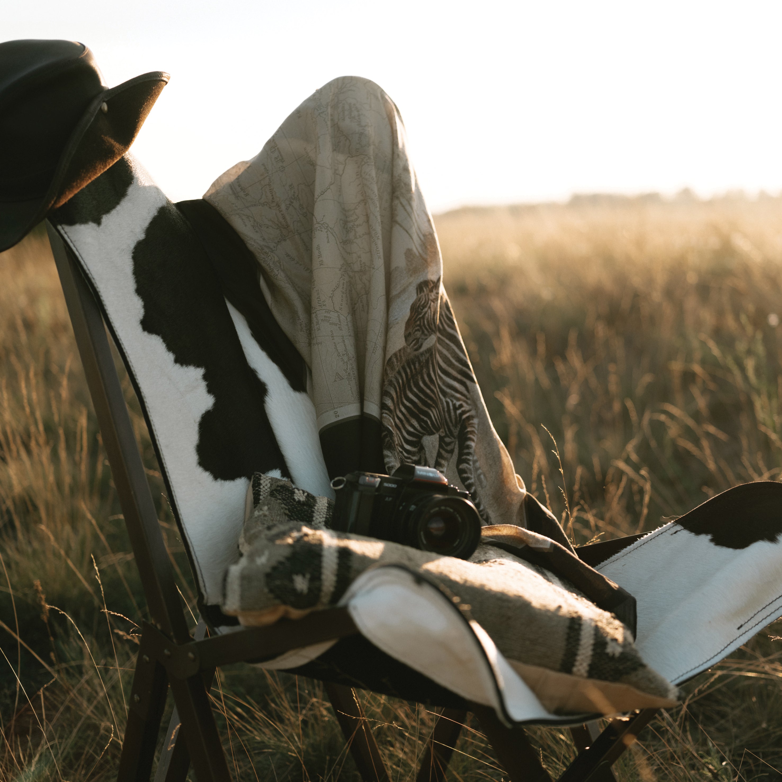 Maouli shawl silk and cashmere Zawadi on chair in field with bright sun shining